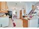 Bright kitchen with tiled flooring, a breakfast bar, and staircase access at 2712 Rolling Broak Dr, Orlando, FL 32837