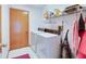 Functional laundry room with white appliances, tile flooring, and ample storage space at 2712 Rolling Broak Dr, Orlando, FL 32837
