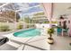 Inviting screened-in pool area with lush landscaping, seating, and a covered dining area at 2712 Rolling Broak Dr, Orlando, FL 32837