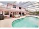 The backyard features a large, enclosed in-ground pool and covered patio for outdoor relaxation at 2712 Rolling Broak Dr, Orlando, FL 32837