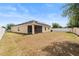Exterior view of the home showing the backyard and screen enclosed lanai at 3345 Reedy Glen Dr, Kissimmee, FL 34758