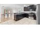 Open kitchen with breakfast bar, stainless steel appliances, and tile flooring at 3345 Reedy Glen Dr, Kissimmee, FL 34758