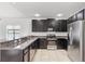 Modern kitchen featuring stainless steel appliances and dark cabinets at 3345 Reedy Glen Dr, Kissimmee, FL 34758
