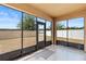 Enclosed lanai with tile floor and large glass doors overlooking the fenced backyard at 3345 Reedy Glen Dr, Kissimmee, FL 34758