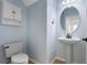 Charming half bathroom featuring a pedestal sink, toilet, and decorative accents for a clean, functional space at 3468 Woodley Park Pl, Oviedo, FL 32765