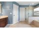 Modern bathroom featuring a glass enclosed shower, soaking tub, and tile floor at 3468 Woodley Park Pl, Oviedo, FL 32765