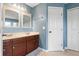 Bathroom featuring double sink vanity, two mirrors, and shower/tub combo at 3468 Woodley Park Pl, Oviedo, FL 32765