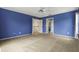 Spacious bedroom featuring plush carpet, ceiling fan, and two entry doors at 3468 Woodley Park Pl, Oviedo, FL 32765