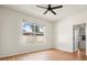 Cozy bedroom with wood-look flooring, a large window, and a ceiling fan at 3468 Woodley Park Pl, Oviedo, FL 32765