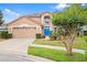 Charming two-story home featuring a well-maintained lawn, a two-car garage, and a vibrant blue front door at 3468 Woodley Park Pl, Oviedo, FL 32765