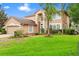 Charming two-story home with a spacious front yard, beautiful landscaping, and a neutral-toned exterior at 3468 Woodley Park Pl, Oviedo, FL 32765