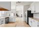 Well-lit kitchen featuring white cabinets, stainless steel appliances, and tile flooring, seamlessly connecting to other rooms at 3468 Woodley Park Pl, Oviedo, FL 32765