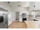 Well-lit kitchen with stainless steel appliances, white cabinetry, tile flooring, and ample counter space at 3468 Woodley Park Pl, Oviedo, FL 32765