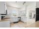 Bright kitchen with white cabinets, modern appliances, tile backsplash, and open layout at 3468 Woodley Park Pl, Oviedo, FL 32765