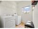 Bright laundry room equipped with washer, dryer, shelving, and a window offering natural light at 3468 Woodley Park Pl, Oviedo, FL 32765