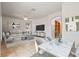 Bright living room featuring tile floors, a ceiling fan, white furniture, and a large television at 3468 Woodley Park Pl, Oviedo, FL 32765
