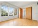 Bright living room with hardwood floors, large windows, and access to hidden room through shelving at 3468 Woodley Park Pl, Oviedo, FL 32765