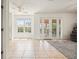 Bright living room featuring sliding glass doors, tile floors, and ample natural light at 3468 Woodley Park Pl, Oviedo, FL 32765