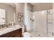 Bright bathroom with a granite countertop vanity and a walk-in shower featuring modern fixtures at 3617 Fort Mellon Ln, Sanford, FL 32773