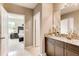 Bathroom with granite countertop, double sinks, and view to the open bedroom at 3617 Fort Mellon Ln, Sanford, FL 32773