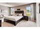 A cozy bedroom featuring a dark wood bed frame with a gray and white comforter set at 3617 Fort Mellon Ln, Sanford, FL 32773