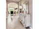Inviting entryway with decorative console table, mirror, and an arched doorway at 3617 Fort Mellon Ln, Sanford, FL 32773