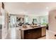 Open concept kitchen with granite countertops and an island with barstool seating, leading to dining at 3617 Fort Mellon Ln, Sanford, FL 32773