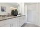 Elegant bathroom featuring dual sinks, granite countertops, and a walk-in shower at 3641 Fort Mellon Ln, Sanford, FL 32773