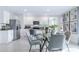 Stylish dining area with modern table and chairs, complemented by a view into the kitchen at 3641 Fort Mellon Ln, Sanford, FL 32773