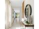 Bright, airy hallway with tile floors, decorative mirror, and art piece for a welcoming atmosphere at 3641 Fort Mellon Ln, Sanford, FL 32773