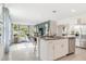 Modern kitchen with granite counters, stainless steel appliances, and open views to the living area at 3641 Fort Mellon Ln, Sanford, FL 32773