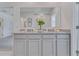 Spacious bathroom featuring double vanity with granite countertop and white cabinetry for ample storage space at 3846 Royal Azalea Way, Sanford, FL 32773