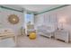 Charming Bedroom with crib, changing table, accent chair, and decorative wall art, creating a warm, inviting space at 3846 Royal Azalea Way, Sanford, FL 32773