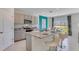 Open kitchen with granite countertop island, stainless steel appliances, and adjacent dining area at 3846 Royal Azalea Way, Sanford, FL 32773