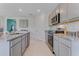 Contemporary kitchen featuring stainless steel appliances, light gray cabinets, and granite countertops at 3846 Royal Azalea Way, Sanford, FL 32773