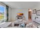 Cozy living room features a large window with outdoor view and modern decor at 3846 Royal Azalea Way, Sanford, FL 32773