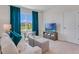 Cozy living room featuring comfortable seating, a TV, and a sunlit window, creating a relaxing atmosphere at 3846 Royal Azalea Way, Sanford, FL 32773