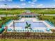 Aerial view of a resort-style pool and clubhouse, surrounded by manicured lawns and lush landscaping at 3850 Royal Azalea Way, Sanford, FL 32773