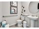 Well-lit powder room featuring a pedestal sink, modern fixtures, and neutral wall decor at 3850 Royal Azalea Way, Sanford, FL 32773