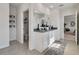 Modern bathroom showcasing double sinks with granite counters, tile floors, and a closet space at 3850 Royal Azalea Way, Sanford, FL 32773
