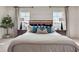 Bedroom with stylish headboard, decorative pillows and ample natural light from two windows at 3850 Royal Azalea Way, Sanford, FL 32773