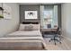 Stylized bedroom with a neutral palette, comfortable bed, desk, and window at 3850 Royal Azalea Way, Sanford, FL 32773