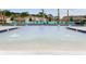 Beautiful community pool featuring a large deck with lounge chairs surrounded by lush landscaping at 3850 Royal Azalea Way, Sanford, FL 32773