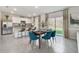 Open-concept dining room adjacent to the kitchen, featuring contemporary decor and ample natural light at 3850 Royal Azalea Way, Sanford, FL 32773