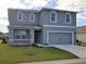 Charming two-story home with a well-maintained lawn and attached two-car garage at 3850 Royal Azalea Way, Sanford, FL 32773