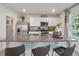 Bright kitchen with granite countertops, white cabinets, stainless steel appliances, and eat-in island at 3850 Royal Azalea Way, Sanford, FL 32773