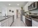Spacious kitchen featuring a pantry, stainless steel appliances, granite countertops, and tile floors at 3850 Royal Azalea Way, Sanford, FL 32773