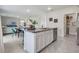 Modern kitchen with granite island and stainless steel dishwasher open to dining and living areas at 3850 Royal Azalea Way, Sanford, FL 32773