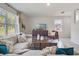 Comfortable living room with ample natural light, stylish decor, and tile flooring at 3850 Royal Azalea Way, Sanford, FL 32773