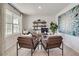 Bright home office featuring a desk, bookshelves, comfortable seating, and a large window at 3850 Royal Azalea Way, Sanford, FL 32773